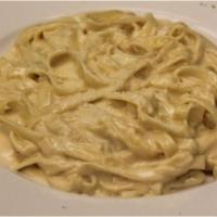 Fettucini Alfredo Pasta · Creamy parmigiano sauce.