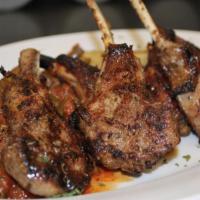 Grilled Rack of Lamb Chops · Served with 2 sides and side of tzatziki. Can be cooked to order, Rare, Med Rare, Medium, Me...