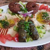 7. Vegetarian Plate · An assortment of stuffed grape leaves, falafel, hummus and baba ghanouj. Served with pita br...