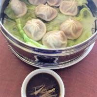 Xiao Long Bao 小笼包 · Delicate tiny purse of dough filled with a little broth and pork filling, severed with fresh...