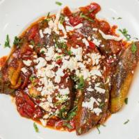 Mussels Saganaki · Greek-style mussels sauteed with tomatoes, peppers, onions and feta cheese.