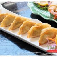 Pot Sticker · Chopped vegetables and ground chicken wrapped in wonton skin, deep fried and served with bla...
