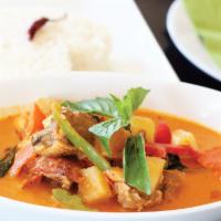 Roasted Duck Curry · Red curry paste in coconut milk with sliced roasted duck, pineapples, tomatoes, bell peppers...
