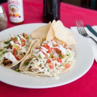 Grilled Salmon Taco · Shredded cabbage, pico de gallo, Anaheim blend, crema and tartar. Tacos are made with handma...