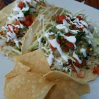 Grilled Mahi Mahi Taco · Shredded cabbage, pico de gallo, Anaheim blend, crema and tartar. . Tacos are made with hand...
