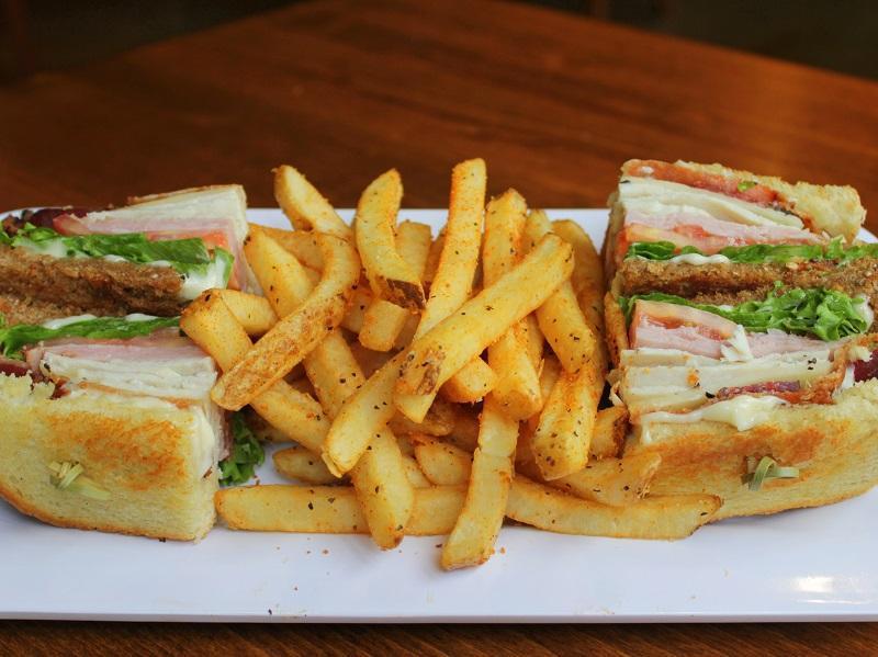 Avocado Club Sandwich · Slow roasted turkey, all-natural ham, thick peppered bacon, Swiss cheese, lettuce, tomato, avocado and mayo on toasted white and wheat bread.