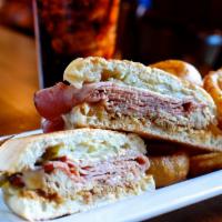 El Cubano Sandwich · Slow roasted pulled pork, all-natural ham, melted Swiss cheese, spicy honey mustard, and pic...