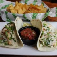 Blazing Onion Tacos · 2 tacos served in warm flour tortillas accompanied with house made chips and salsa.