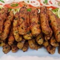 9. Seekh Kebab · Ground lamb blended with finely chopped onions, peppers, and spices. Cooked in the tandoor.