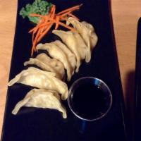 GYOZA · 6 pieces. Charred stuffed chicken and vegetable.