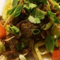Naam Tok Salad · Steak salad. Grilled flank steaks in lime dressing, red onion, tomato, scallions, cilantro a...