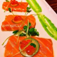 Salmon Confit · Salmon sashimi topped with cucumber, ikura and wasabi sauce.