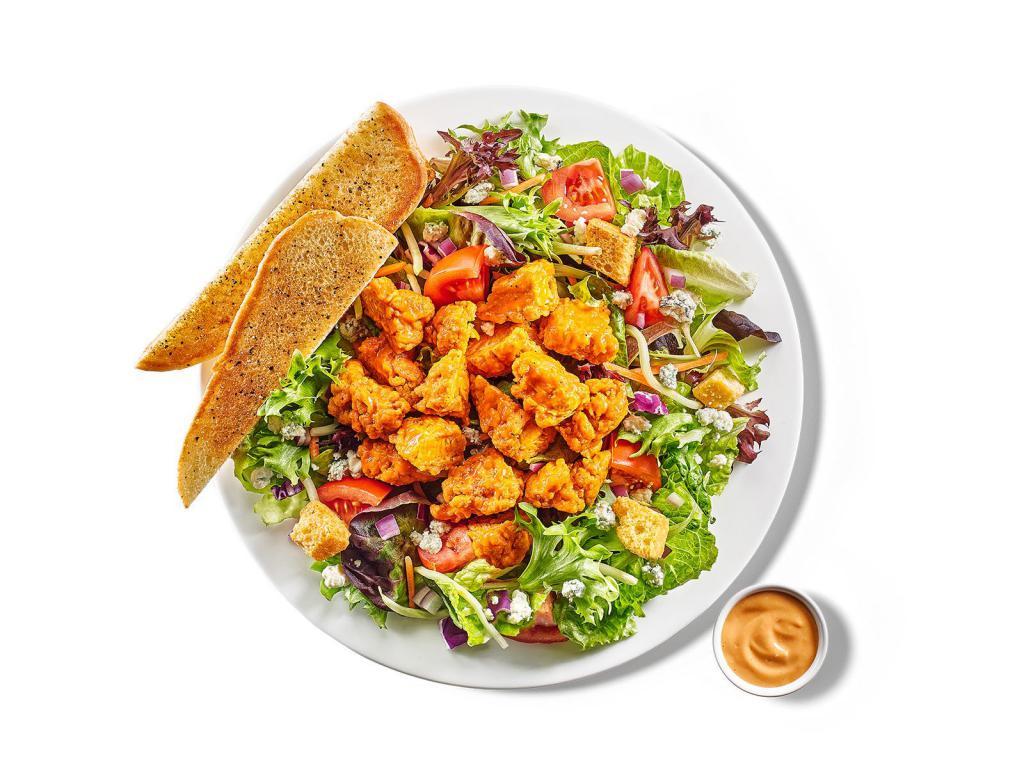 Buffalo Chicken Salad · all white meat buffalo chicken / choice of mild, medium or hot buffalo sauce / house greens / tomato / onion / bleu cheese crumbles / croutons / bleu cheese dressing / garlic toast not included