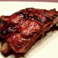 6. Pork Baby Back Ribs Special · 1/2 baby back ribs and BBQ sauce. Served with rice and 2 sides.