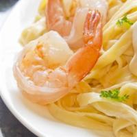Fettuccine Shrimp Alfredo · Large shrimp with our homemade Alfredo sauce on a bed of fettuccine pasta dusted with parmes...