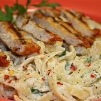 Fettuccine Chicken Alfredo · Our delicious homemade Alfredo sauce on a bed of fettuccine pasta dusted with Parmesan chees...