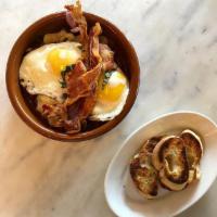 Huevos Rotos · “Spanish Broken Eggs”; Sauteed Patatas Bravas, Red Pepper, Onions, Topped with Two Sunny Eggs