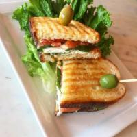 Capresse Sandwich · Fresh mozzarella, tomato, basil and black olives. Served with chips. Served on rustic panini...