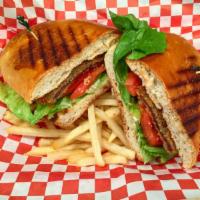 Milanesa Sandwich · Breaded veal or chicken, lettuce and tomato. Served with french fries or salad. Served on ho...