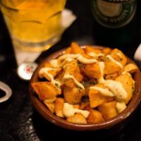Patatas Bravas · Home cut potatoes seasoned in spicy paprika and aioli sauce.
