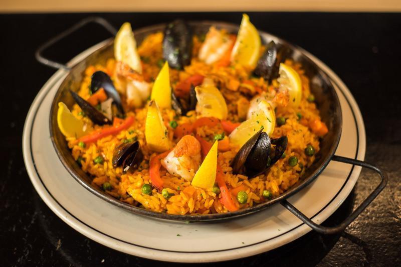 Seafood Paella · Squid, mussels, shrimp, clams in saffron and paprika rice.