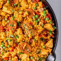 Chicken Paella · Spanish Rice, Saffron, Sweet Red Pepper, Onions, Chicken Breast