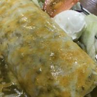 Wet Veggie Burrito · Rice, beans with cheese, lettuce, tomatoes covered in red or green sauce with sour cream.