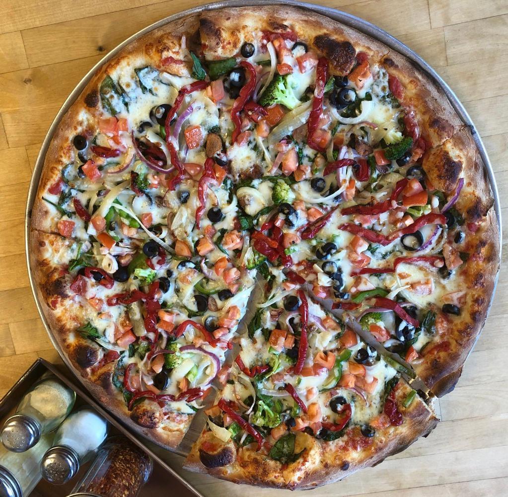 * Vibrant Veggie Pizza · Spinach, broccoli, white and red onions, fresh tomatoes, red and green peppers, roasted garlic, black olives, mushrooms, caramelized onions and mozzarella. Vegetarian.