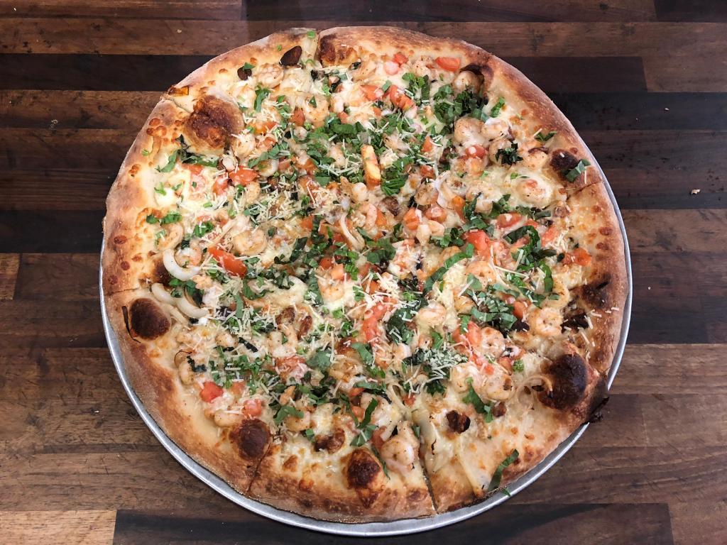 * Shrimp Scampi White Pizza (Spicy) · Shrimp sauteed in our own homemade white wine sauce and topped with onion, diced tomato, roasted garlic, fresh basil and mozzarella. Spicy.