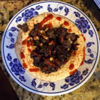 Hummus Kawarma · Hummus topped with sauteed filet Mignon and pine nuts.