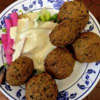 Falafel · 5 pieces. Crushed garbanzo beans mixed with spices, herbs and fried. Vegan.
