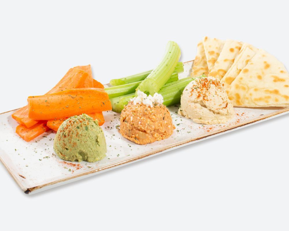 Dip Trio · Your choice of 3 dips: garlic dip, spicy feta, organic original hummus or spicy hummus. Served with veggies and pita bread. Vegetarian and spicy.