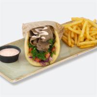 Gyro Pita Wrap · Greek cabbage salad, shredded kale, diced tomato, spicy tzatziki, gyro meat wrapped in pita.