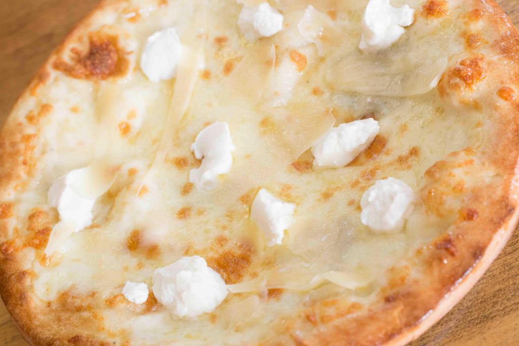 Four Cheese Pizza · White pie. Goat cheese, Gorgonzola, and parmigiano.