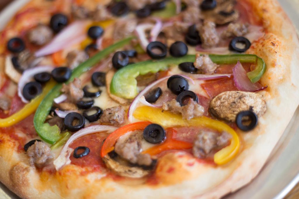 Baiano Combo Pizza · Red pie. Salami, pepperoni, sausage, mixed bell peppers, onions, mushrooms, and black olives.