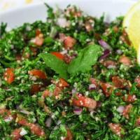 Tabbouleh Salad · Tomatoes, parsley, scallions, cracked wheat, lemon juice and spices.