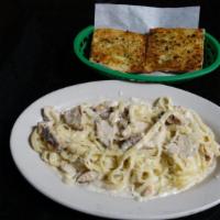 Chicken Alfredo pasta · Grilled Chicken sautéed with fettuccini and Alfredo sauce topped with parmesan cheese