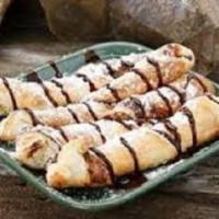 Pow Pows · Baked dough twisted with a hazelnut sauce, powdered sugar and chocolate sauce. 