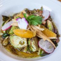 Brussels Sprouts · Crispy Brussels sprouts sauteed in hoja herb and vinaigrette, with roasted pumpkin seeds, al...