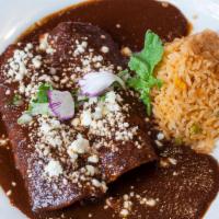 Enchiladas de Mole · Simmered in signature mole poblano sauce, 2 corn tortillas  filled with your choice of chick...
