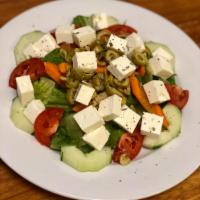 GREEK SALAD · Delicious cubes of Feta Cheese on top of freshly cut Romain lettuce, Tomatoes, Cucumbers, Ca...