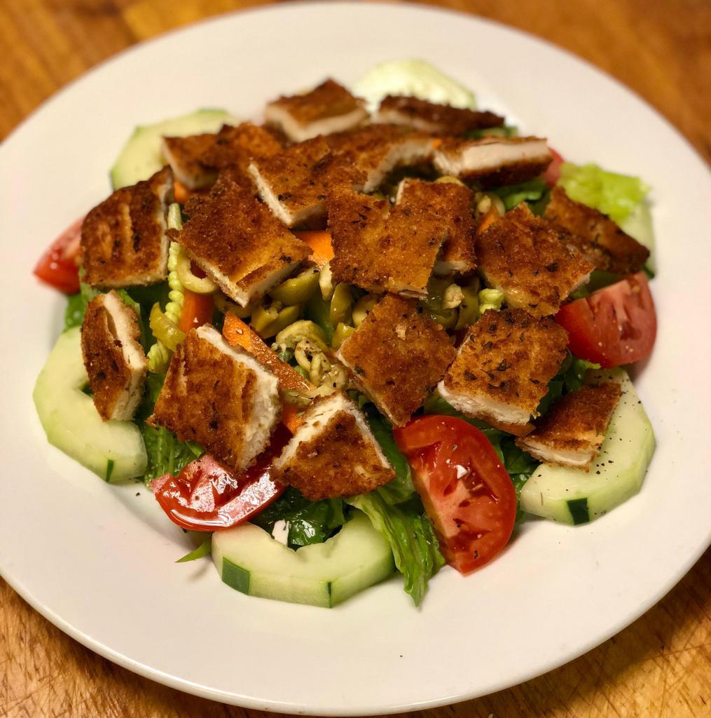 BREADED CHICKEN SALAD · Freshly breaded Chicken cutlet cut into strips served over Romain lettuce, Tomatoes, Cucumbers, Carrots and Green olives. Comes with bread & 2 cups of your choice of dressing on the side.