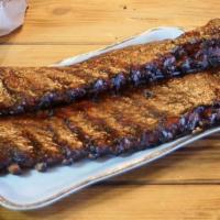 Whole Rack of Ribs · A whole rack of tender pork ribs dry rubbed with our secret rib rub spices and then basted w...