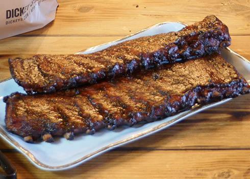 Whole Rack of Ribs · A whole rack of tender pork ribs dry rubbed with our secret rib rub spices and then basted with our sweet barbecue sauce and slow smoked for four overs over hickory wood. Feeds 3-4 folks.