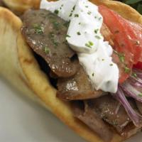 Gyro Traditional · Slice of lamb on a pita bread with tomatoes, onions, lettuce and tzatziki sauce. Served with...