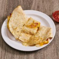Quesadilla · A large flour tortilla stuffed with scrambled eggs, melted cheddar and Jack cheese and your ...