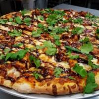 BBQ Chicken Pizza · BBQ sauce, chicken, red onions, cilantro and mozzarella cheese.