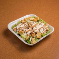 42. Chicken Caesar Salad · Chicken breast and Parmesan cheese on a bed of romaine lettuce.