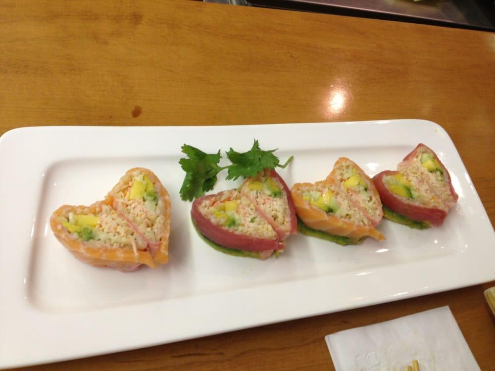 Sweet Heart Roll · Spicy crab meat, avocado, cucumber, mango top with tuna, salmon and avocado with chef special sauce.