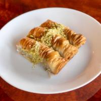 63. Planet’s Baklava · 3 rolls of homemade baklava stuffed and topped with fresh pistachio.